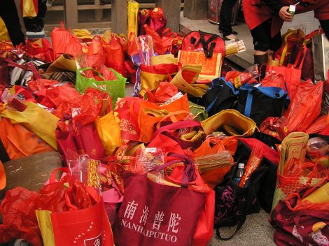 Just one of the many piles of bags filled with gifts for the gods